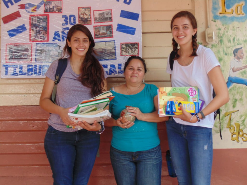 Kerene and Rachel with the Principal  Emma of La Amistad School, receiving school supplies as donations.