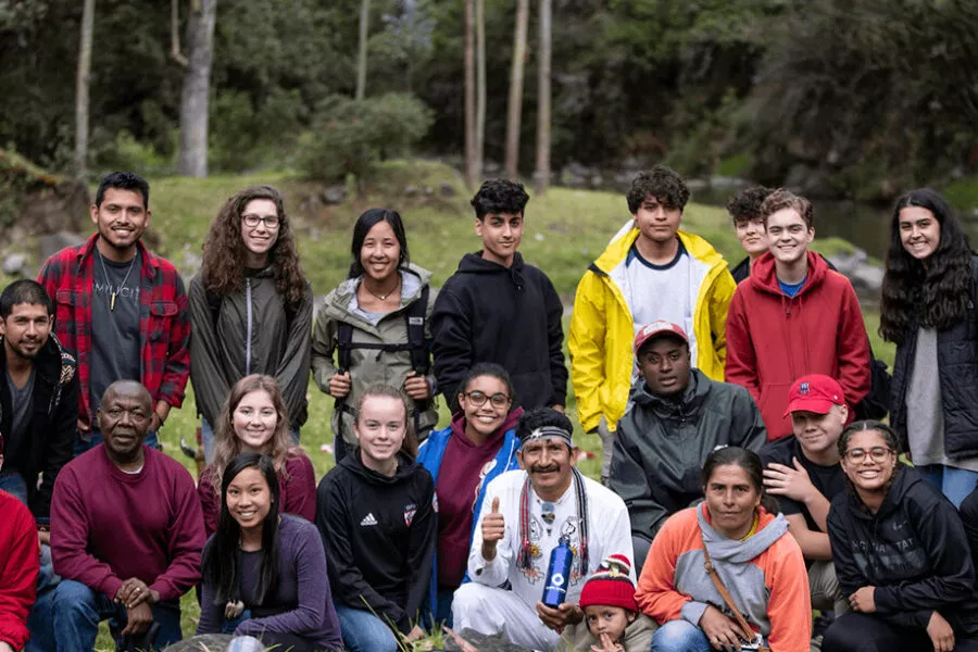 Group of students posing with a shaman