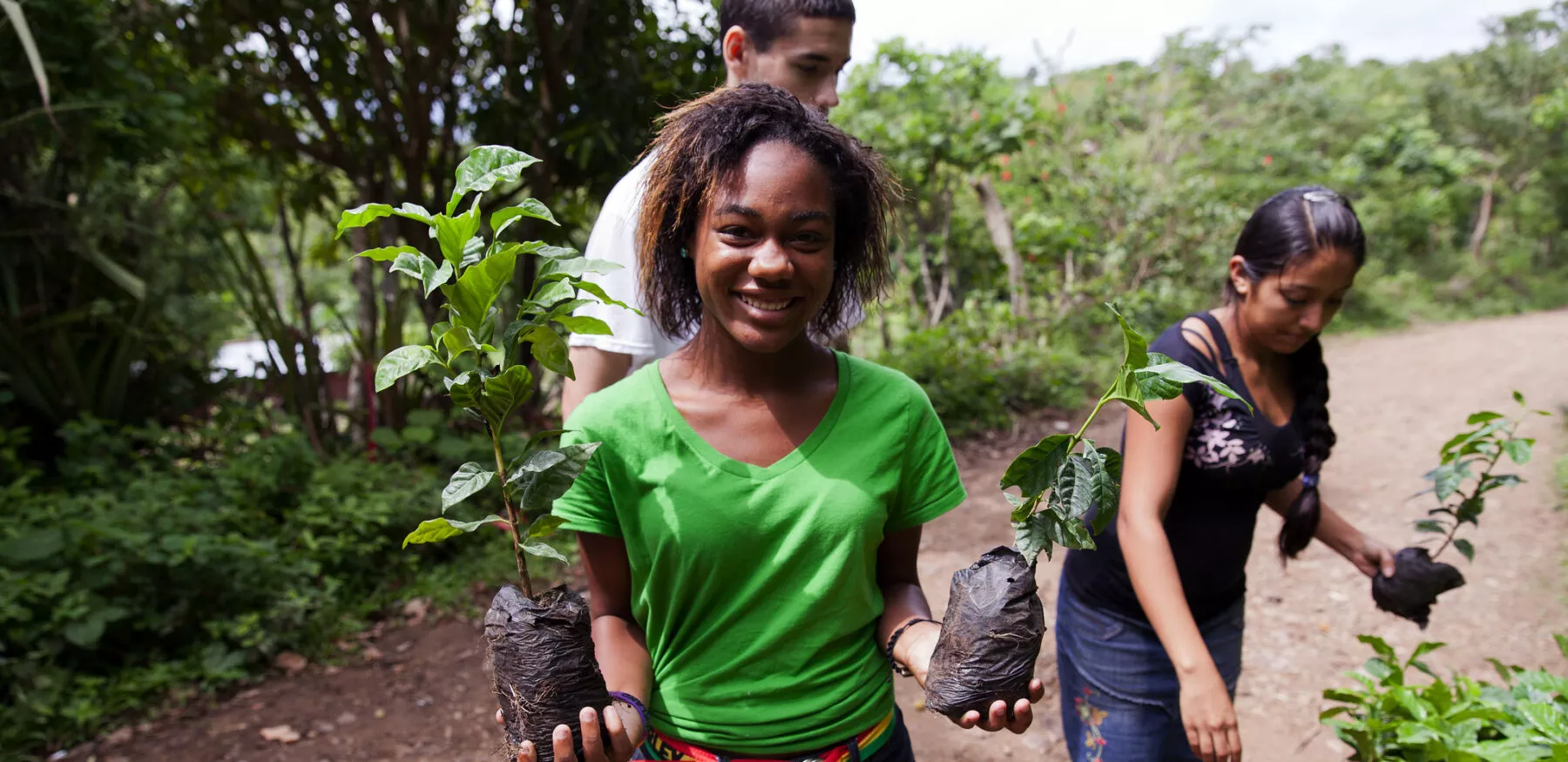 This photo of a Global Glimpse member planting and gardening aims to encourage viewers to apply to their programs.