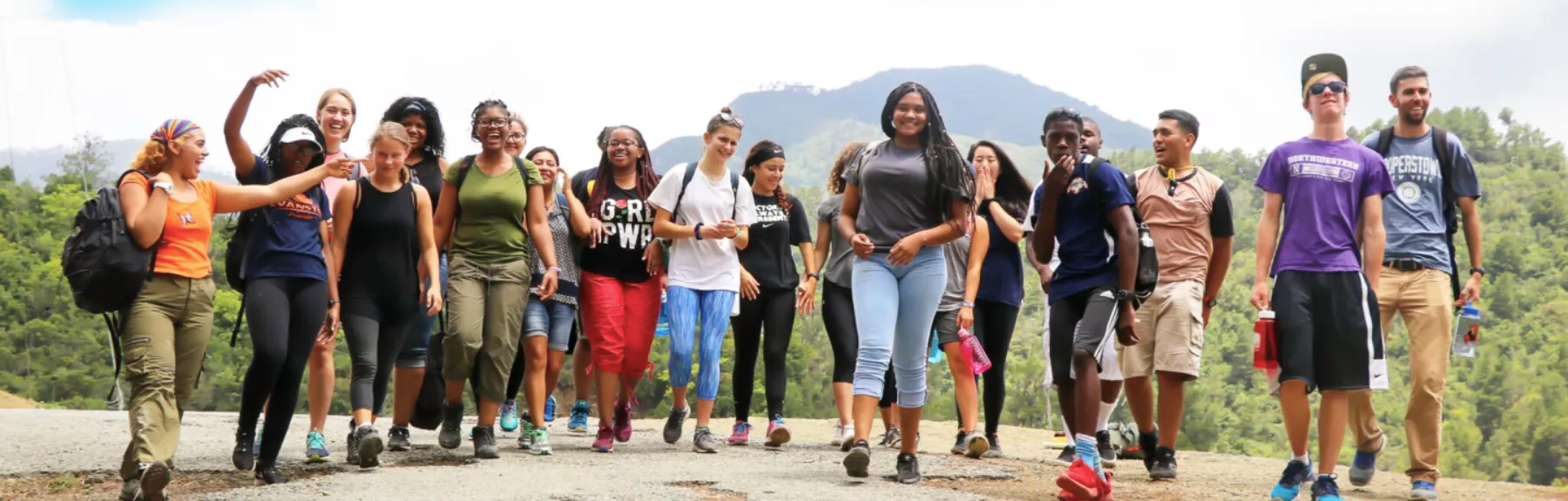 Large group of students walking toward the camera in various candid poses