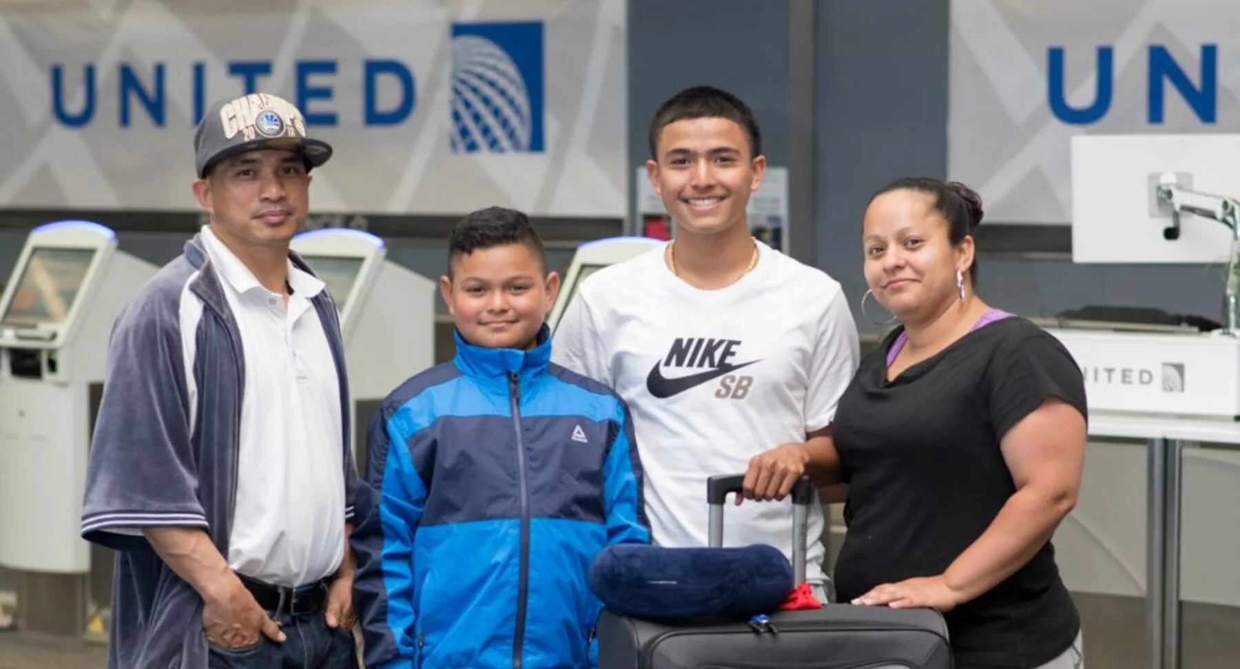 Family At United Check In Desks in Airport