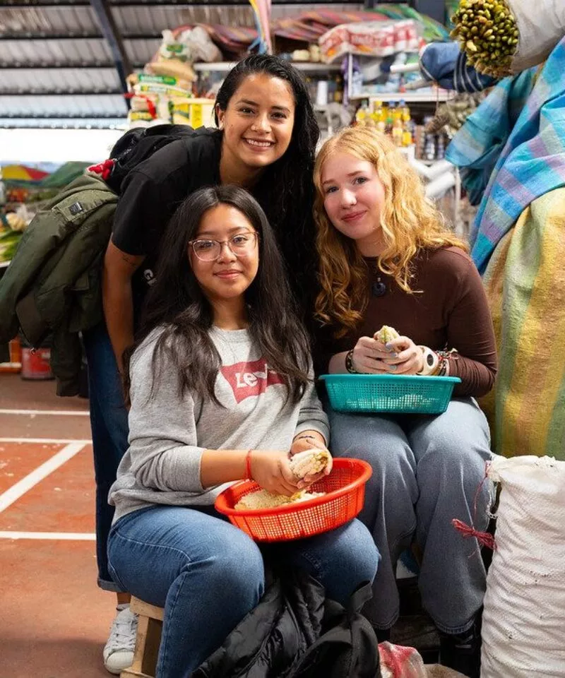Three girls looking at the camera of different racial backgrounds