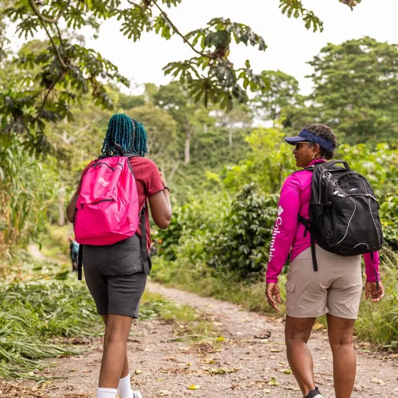 Two females with backpacks talking and walking away from the camera